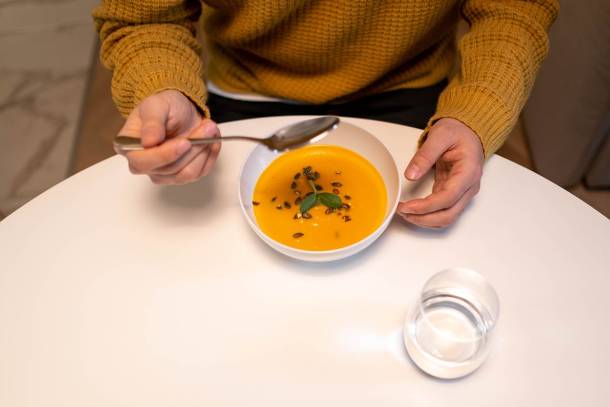 A Person Eating Pumpkin Soup 