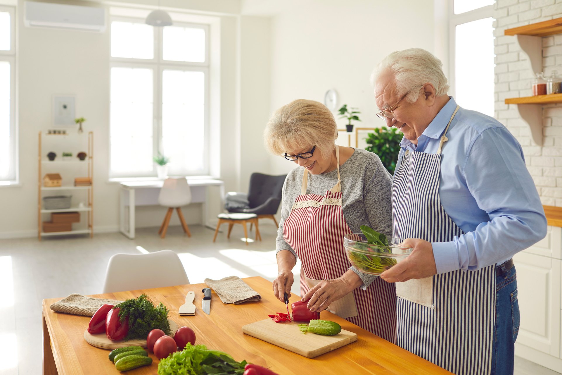 Happy Mature Couple Cooking Healthy Lunch Together in the Kitchen of Their Modern Apartment